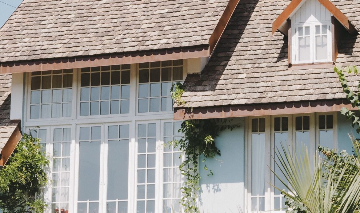Residential home with a shingle roof under a blue sky