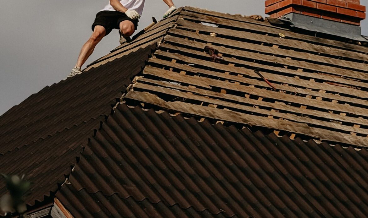 Roofing professional performing repair work on a residential roof