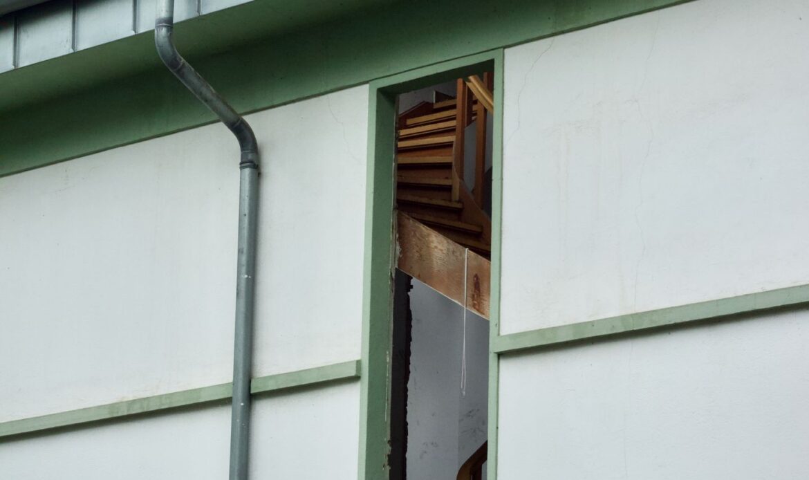 Residential property with visible roof damage after severe weather